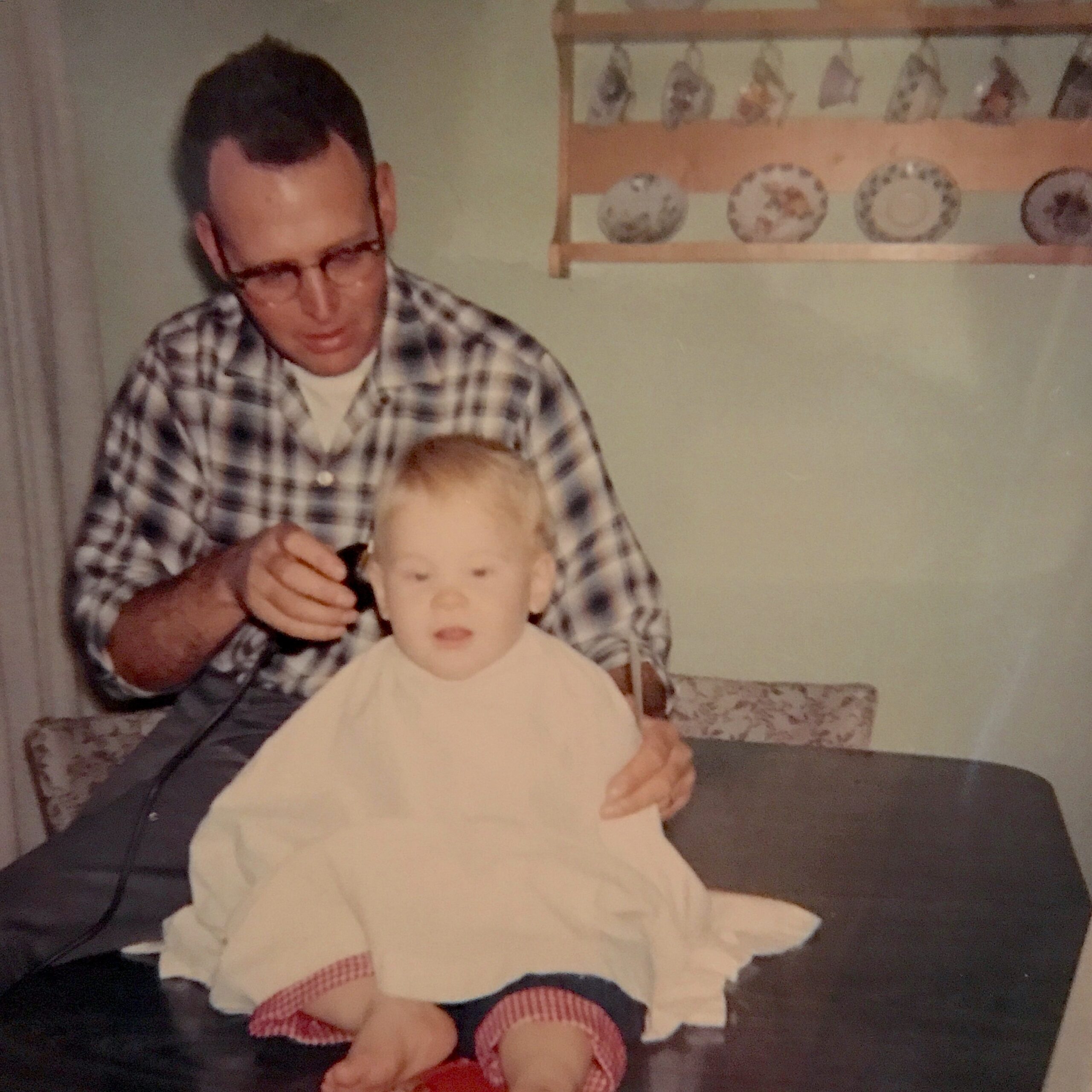 Gary's dad gives gives him a haircut.